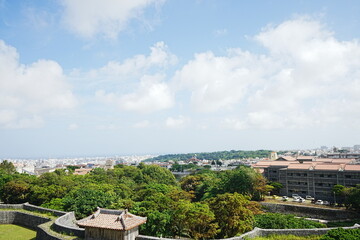 Fototapeta na wymiar Aerial view of Naha city and sea shore from Shurijo castle in Okinawa, japan. Panorama - 沖縄 那覇市の街並みと海 
