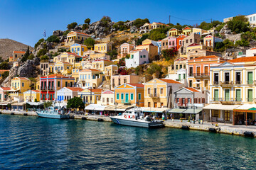 View of the beautiful greek island of Symi (Simi) with colourful houses and small boats. Greece, Symi island, view of the town of Symi (near Rhodes), Dodecanese. - 657134324