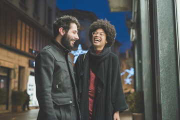 Fototapeta na wymiar young multiethnic couple posing outdoor smiling having fun laughing