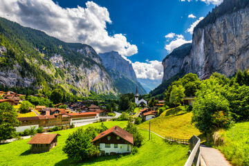 Amazing summer landscape of touristic alpine village Lauterbrunnen with famous church and Staubbach waterfall. Location: Lauterbrunnen village, Berner Oberland, Switzerland, Europe. - 657136309