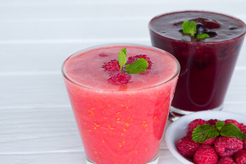 Blueberry  mix  raspberry  Juice smoothies drink in a glass drink purple colorful fruit juice milkshake blend beverage healthy high protein the taste yummy in glass on white wood background.