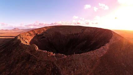 Drone shot of the volcano Calderón Hondo and his huge crater at sunset on the island of Fuerteventura in Spain