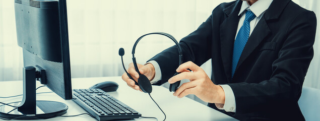 Business people wearing headset working in office to support remote customer or colleague. Call...