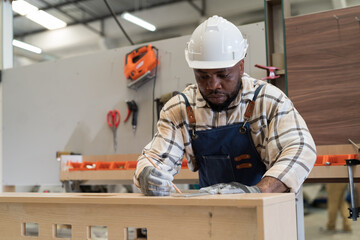Male carpenter working in carpentry workshop. Male joiner working in wood factory