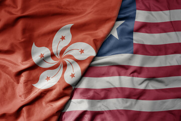 big waving realistic national colorful flag of hong kong and national flag of liberia .