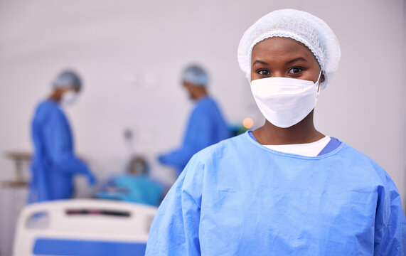 Portrait, woman and surgeon in operating room, hospital and surgery for medical emergency. Healthcare, african doctor and clinic expert in face mask, scrubs and ppe for working in operation theatre