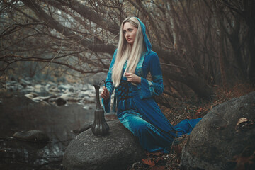 Beautiful celtic woman. Fantasy ritual near winter stream - 657161324