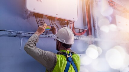 Technician Engineering use thermal imaging camera to check temperature of instalation inverter solar panel in factory
with shiny light and space  text.