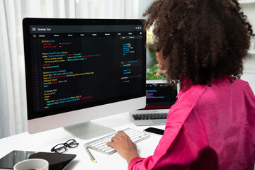 African American woman's programing developer. Coding Software project on computer screen server at...