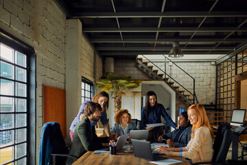 Young and diverse group of designers having a meeting in an office while working in a startup company