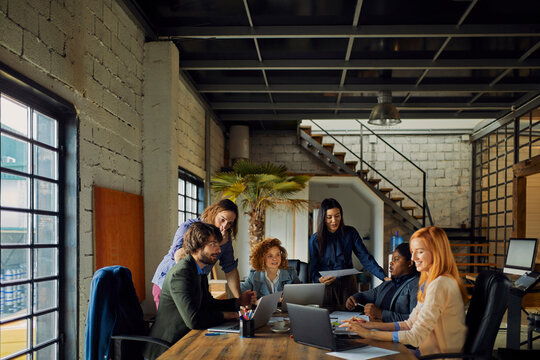 Young and diverse group of designers having a meeting in an office while working in a startup company