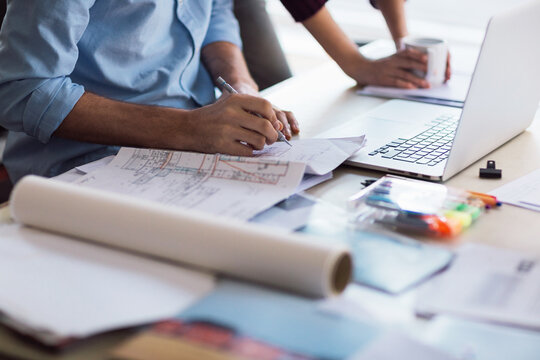 Close-Up of hands of a architect working on building plans in the office