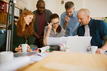 Group of people working together on a project in a startup company office