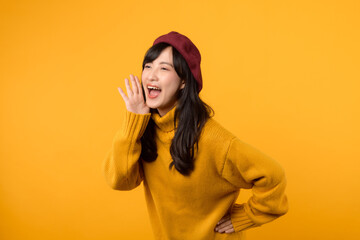 Vibrant communication. Asian woman in her 30s announces with flair, donning a yellow sweater and...