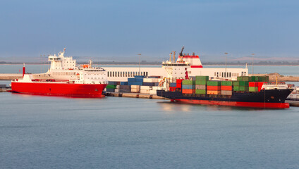 Large container ship in the cargo port of Cadiz at sunset.