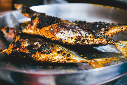 Fried mackerel fish on the plate. Close up.