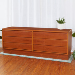 Sleek teak dresser. Vintage 1970s style furniture.