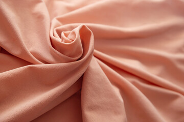 Soft focus texture of the silk fabric, soft pink. Peach pink fabric background.  Crumpled soft rose...