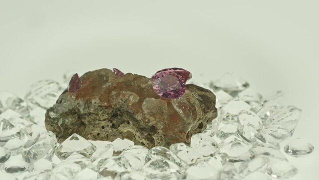 .Pink amethyst diamonds on raw opal lump The colors of the gems shone brilliantly, .creating a beautiful contrast in the light. .The gems were expertly crafted, making them a rare and valuable find.