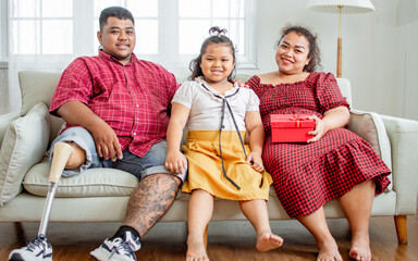 Portrait three people asian family, happy father, husband with disable prosthetic leg, giving red...