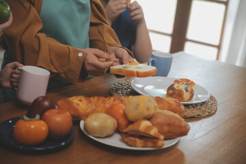 Caucasian attractive couple baking bakery with son in kitchen at home. Happy Family-father, mother and young boy having fun spending time together using ingredient making foods. Activity relationship.