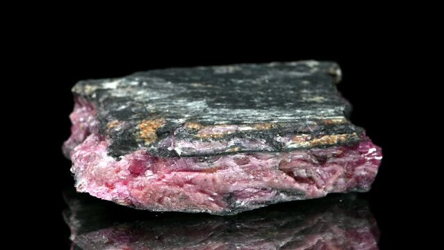 Rhodonite (Manganese inosilicate - Manganese ore) specimen rotating slowly against a black background.
