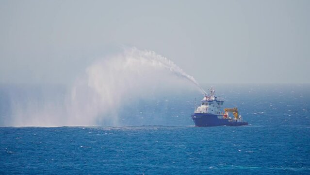 4k, view of ship, boat, tugboat, Red Sea, splashes with water,fire extinguisher training, port of Yanbu, Saudi Arabia 