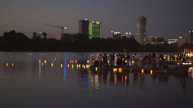 Amazing floating lantern lights festival are released on the lake by people at night. Celebrate lantern festival of light