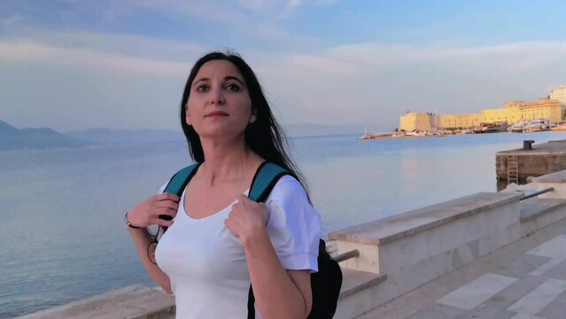 A tourist observes the view while walking along the Gaeta seafront