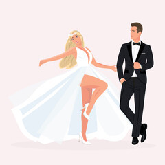 The bride in white dress and groom in black tuxedo dance at the wedding.