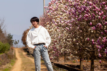 Fototapeta na wymiar Little Korean boy wearing white shirt outdoors