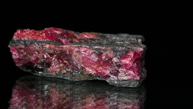Rhodonite (Manganese inosilicate - Manganese ore) specimen rotating slowly against a black background.