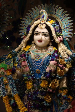 Goddess Radha with beautiful clothing and jewellery, decorated with bright blue cloth at an Indian temple