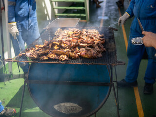 detail of roasted meat on top a barbeque