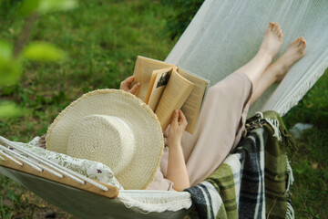 Harmony in a backyard haven a woman, a book, a hammock. A tranquil snapshot of slow living, a joyful escape from the urban hustle