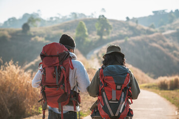 Travelers hiking with backpack traveling in forest wild and look around and explore while walking...