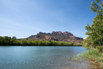 Rocher de Roquebrune and the Argent River in foreground with copy space, Roquebrune-sur-Argens, France, a tourist destination in Summer