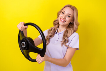 Photo of cheerful cute lady wear purple polo enjoying riding automobile isolated yellow color background