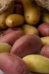 Red and yellow potatoes in weaved basket.