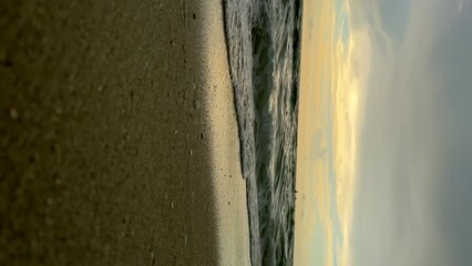Ocean wave at sunrise. Slow motion footage on sunset. Vertical shot - Powered by Adobe