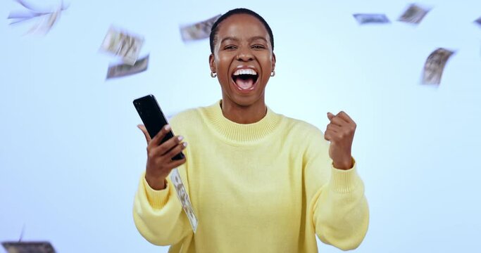 Money rain, smartphone and happy black woman with win, financial freedom and social media giveaway on blue background. Bonus, salary or income, lotto winner in portrait and online prize in studio