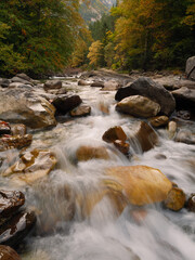 Pyrenean river in autumn with a waterfall in the foreground