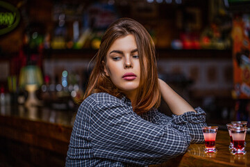 Woman drinking alcohol. Scotch whiskey glass isolated at bar or pub in alcohol abuse and alcoholic concept. Drunk woman holding a glass of whisky or rum. Woman in depression