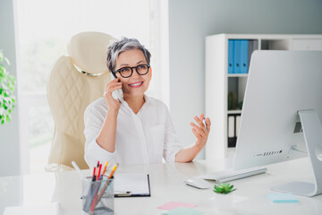 Photo of good mood smiling lady accountant wear white shirt communicating modern device indoors...
