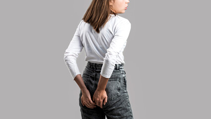 Hemorrhoids. Anus. Pain. Woman hand holding her bottom because having Abdominal pain and...