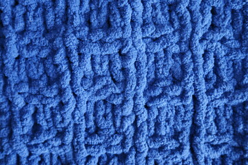 Dark blue handmade knitting blanket background.