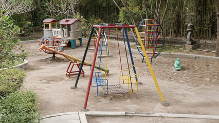 Colorful children's playground in the garden courtyard protected with sandbox