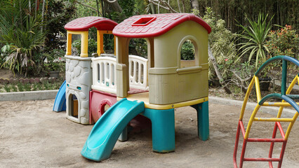 Colorful children's playground in the garden courtyard protected with sandbox