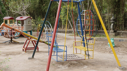 Colorful children's playground in the garden courtyard protected with sandbox