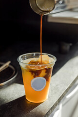 Bumble cold iced refreshing coffee drink with orange juice in the making - 657273938